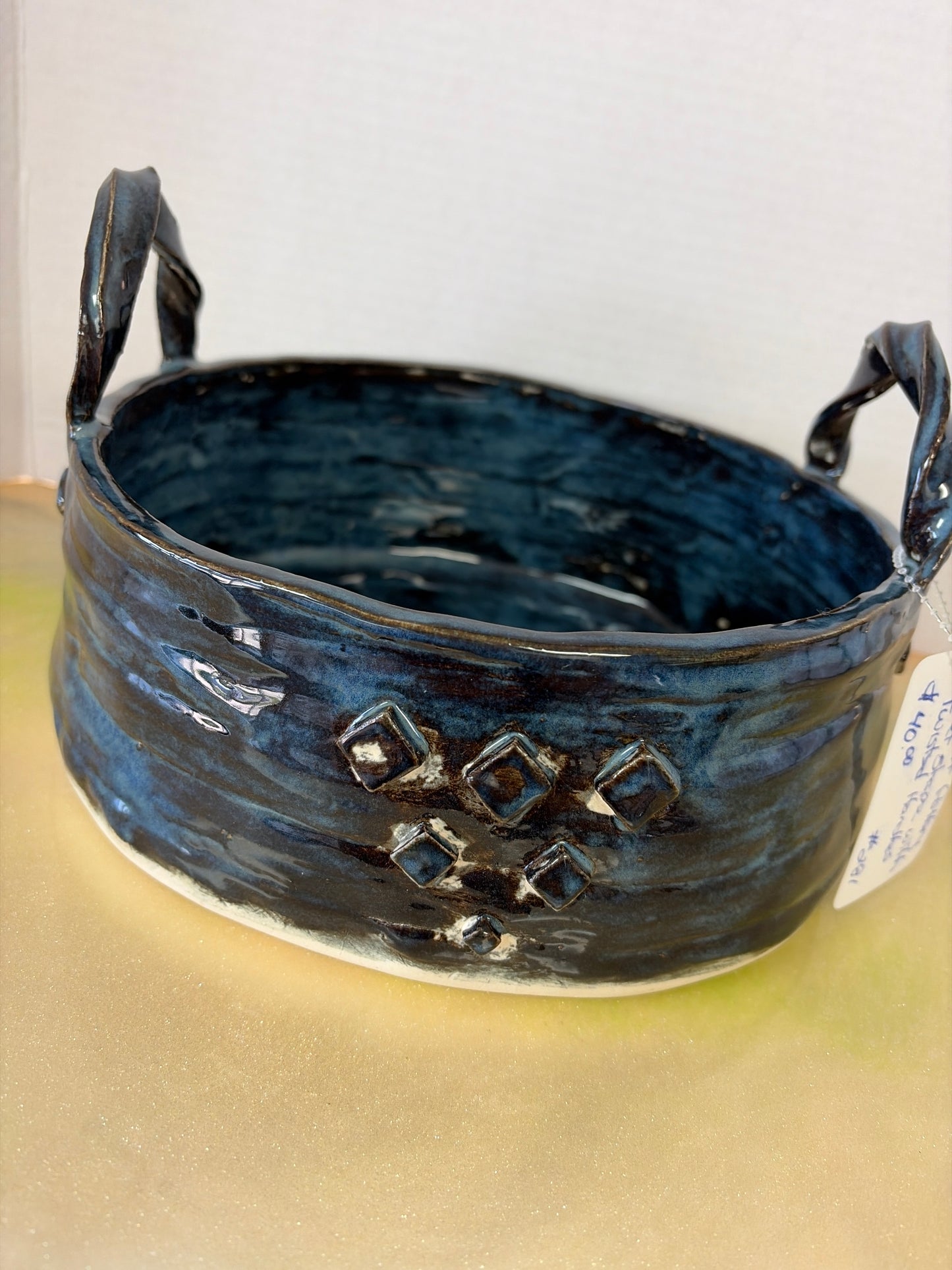 Handmade pottery basket with twisted handles