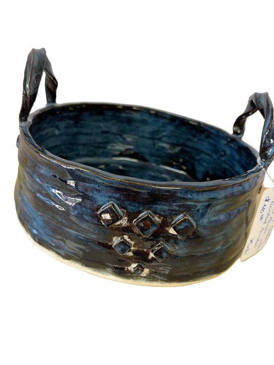 Handmade pottery basket with twisted handles