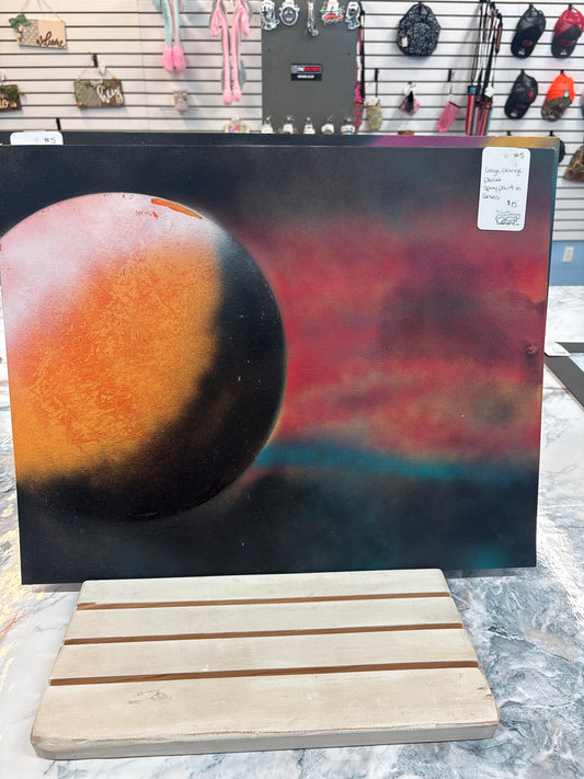 Large orange planet spray painted on canvas ￼