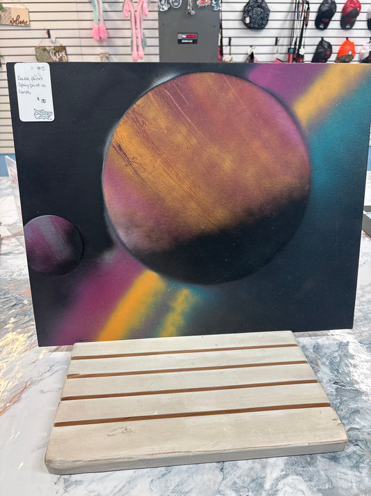 Double planet spray painted on canvas